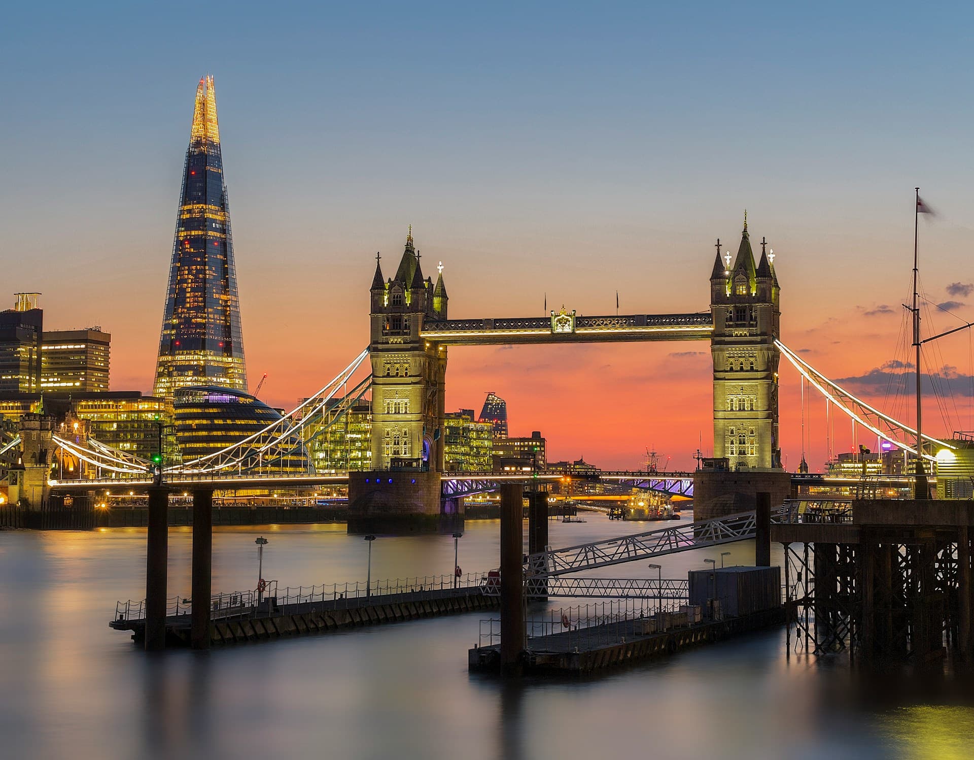 London's tower bridge with a red and pink sunset in the background