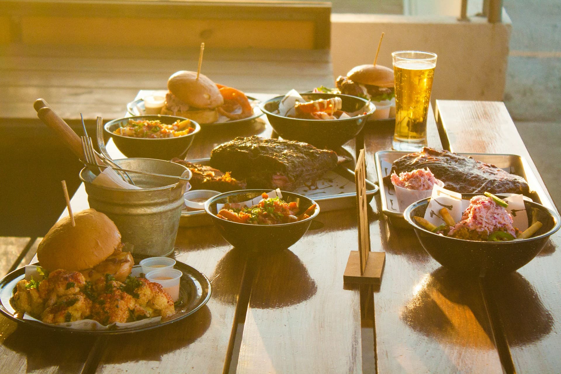 Bright and sunny, with a whole table of many different food and drinks
